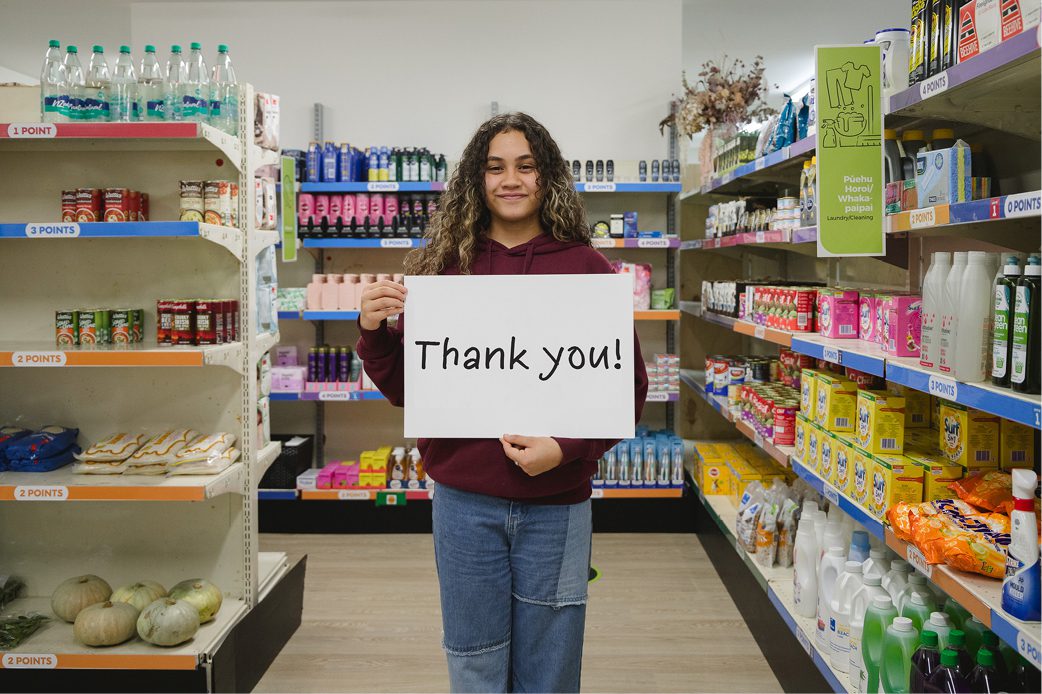 Two women cutting birthday cake