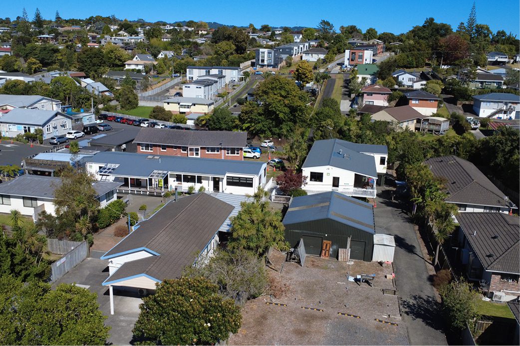 Young boy looking out rainy window